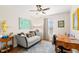 Comfortable living room with a cozy sofa, area rug, artwork, and desk area near a window at 19487 Roseate Dr, Lutz, FL 33558
