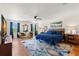 Large main bedroom with hardwood floors, sitting area, TV, and ample natural light from multiple windows at 19487 Roseate Dr, Lutz, FL 33558