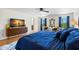 Spacious bedroom featuring hardwood floors, TV, decorative seating, and large windows with bright natural light at 19487 Roseate Dr, Lutz, FL 33558
