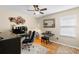 Dedicated home office with a wooden desk, comfortable blue chair, and a decorative mirror at 19487 Roseate Dr, Lutz, FL 33558