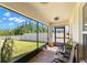 Relaxing screened patio with brick flooring, views of the backyard, and comfortable seating at 19487 Roseate Dr, Lutz, FL 33558