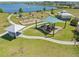 Community playground with modern equipment, a shaded area, and beautiful lake views at 19487 Roseate Dr, Lutz, FL 33558