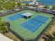 Aerial view of community tennis courts with a covered picnic area and parking at 19487 Roseate Dr, Lutz, FL 33558