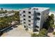 Exterior view of a condo building near the beach, featuring balconies, beach access, and convenient parking at 19600 Gulf Blvd # 102, Indian Shores, FL 33785