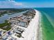 Expansive aerial view of waterfront community near the beach, perfect for coastal living at 19727 Gulf Blvd # 210, Indian Shores, FL 33785