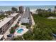 Breathtaking aerial view showcasing the condo with a pool and proximity to the beautiful beach at 19727 Gulf Blvd # 210, Indian Shores, FL 33785