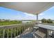 Relaxing view from the covered balcony with outdoor seating and a scenic vista at 19727 Gulf Blvd # 210, Indian Shores, FL 33785