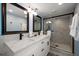 Modern bathroom boasting double vanity, marble countertops and walk-in glass shower at 19727 Gulf Blvd # 210, Indian Shores, FL 33785