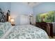 Comfortable bedroom featuring light blue walls, hardwood flooring and a large TV at 19727 Gulf Blvd # 210, Indian Shores, FL 33785