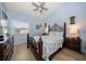 Bedroom featuring light blue walls, hardwood flooring and nautical themed decor at 19727 Gulf Blvd # 210, Indian Shores, FL 33785