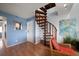 Inviting entryway features a unique spiral staircase, stylish mirror, and decorative accents at 19727 Gulf Blvd # 210, Indian Shores, FL 33785