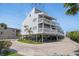 Stunning three-story beach house with elevated construction, multiple decks, and ample parking at 19727 Gulf Blvd # 210, Indian Shores, FL 33785