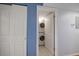 A compact laundry area with a stacked washer and dryer, neatly tucked behind a white door at 19727 Gulf Blvd # 210, Indian Shores, FL 33785