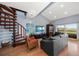 Contemporary living room featuring hardwood floors, spiral staircase, and access to a balcony at 19727 Gulf Blvd # 210, Indian Shores, FL 33785