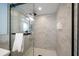 Modern walk-in shower with marble tile, sleek fixtures, and a glass door at 19727 Gulf Blvd # 210, Indian Shores, FL 33785