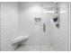 Bright bathroom featuring a glass shower, white tile and built in bench at 199 Dali Blvd # 902, St Petersburg, FL 33701