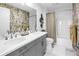 The bathroom features a double vanity, unique wallpaper and a shower and tub combination at 199 Dali Blvd # 902, St Petersburg, FL 33701