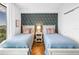 Cozy bedroom featuring twin beds and floral wallpaper at 199 Dali Blvd # 902, St Petersburg, FL 33701
