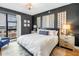 Modern bedroom boasts dark accent wall, plush bed, city views from the large window at 199 Dali Blvd # 902, St Petersburg, FL 33701
