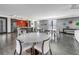 Elegant dining area with round tables, modern chairs, and a stylish kitchenette at 199 Dali Blvd # 902, St Petersburg, FL 33701