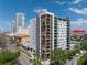 Modern condo building featuring a mix of white and brown panels with private balconies in an urban setting at 199 Dali Blvd # 902, St Petersburg, FL 33701