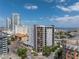 Street-level view of a modern apartment building with visible balconies and street-side landscaping at 199 Dali Blvd # 902, St Petersburg, FL 33701