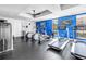 Modern fitness center with treadmills, elliptical machines, and a sleek black ceiling fan, enhancing the community appeal at 199 Dali Blvd # 902, St Petersburg, FL 33701