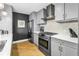 Modern kitchen with stainless steel appliances, gas range, designer backsplash and sleek gray cabinets at 199 Dali Blvd # 902, St Petersburg, FL 33701