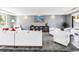 Modern lounge area featuring stylish white furniture and a decorative bookcase with city skyline art at 199 Dali Blvd # 902, St Petersburg, FL 33701