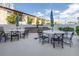 Outdoor dining area with multiple tables, chairs, and a built-in grill for entertaining at 199 Dali Blvd # 902, St Petersburg, FL 33701