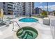 Outdoor swimming pool and hot tub, with lounge chairs and views of a modern building at 199 Dali Blvd # 902, St Petersburg, FL 33701