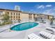Rooftop swimming pool surrounded by lounge chairs and umbrellas on a sunny day at 199 Dali Blvd # 902, St Petersburg, FL 33701