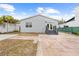 Exterior showcasing a backyard with a patio, stairs to the house, and a well-maintained lawn at 212 N Bradford Ave, Tampa, FL 33609