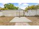 Backyard basketball area, with concrete, a hoop, and a fence in a yard with trees at 212 N Bradford Ave, Tampa, FL 33609
