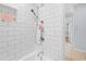 Bright white tiled shower with modern fixtures in updated bathroom at 212 N Bradford Ave, Tampa, FL 33609