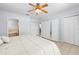 Bedroom with ceiling fan, multiple closets, and doorway to ensuite bath at 212 N Bradford Ave, Tampa, FL 33609