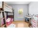 Bedroom with hardwood floors, wooden bunkbed, a desk, and natural light at 212 N Bradford Ave, Tampa, FL 33609