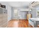 Light bedroom featuring wood floors and a modern loft bed with built in desk at 212 N Bradford Ave, Tampa, FL 33609