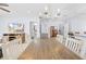 Spacious dining room with hardwood table, modern chandelier, and seamless transition to adjacent rooms at 212 N Bradford Ave, Tampa, FL 33609