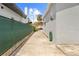 Long driveway with concrete, leading to a backyard gazebo and potential parking at 212 N Bradford Ave, Tampa, FL 33609