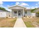 Charming single-story home with a covered front porch, neat landscaping, and a walkway leading to the entrance at 212 N Bradford Ave, Tampa, FL 33609