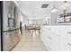 Modern kitchen with stainless steel appliances opens to a dining area at 212 N Bradford Ave, Tampa, FL 33609