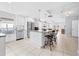 Bright kitchen with stainless steel appliances, center island, granite countertops, and tile flooring at 212 N Bradford Ave, Tampa, FL 33609