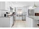 Well-lit kitchen with stainless steel appliances, white cabinetry and granite countertops at 212 N Bradford Ave, Tampa, FL 33609