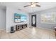 Living room featuring tile floor, a ceiling fan, a front door, and a TV at 212 N Bradford Ave, Tampa, FL 33609