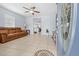 Cozy living room featuring tile floors, a comfortable leather sofa, and an open doorway to the kitchen at 212 N Bradford Ave, Tampa, FL 33609