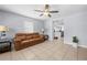Cozy living room featuring tile floors, natural light, a ceiling fan, and ample seating at 212 N Bradford Ave, Tampa, FL 33609