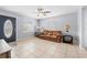 Living room featuring tile floor, a ceiling fan, and a leather couch at 212 N Bradford Ave, Tampa, FL 33609
