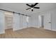 Bedroom featuring new flooring and a walk-in closet with sliding barn doors to bathroom at 2156 Greenbriar Blvd, Clearwater, FL 33763