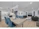 Open-concept living and dining area with modern lighting and decor, seamlessly connecting to the kitchen and living spaces at 2156 Greenbriar Blvd, Clearwater, FL 33763